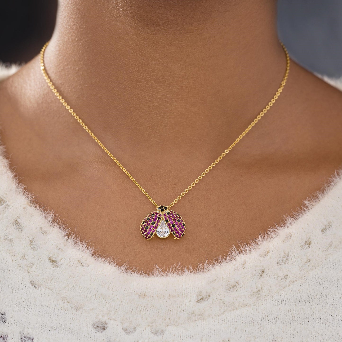 golden necklace with lady bug pendant