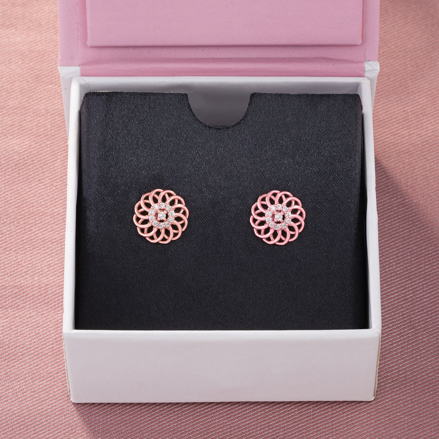 pair of rose gold earrings with diamonds