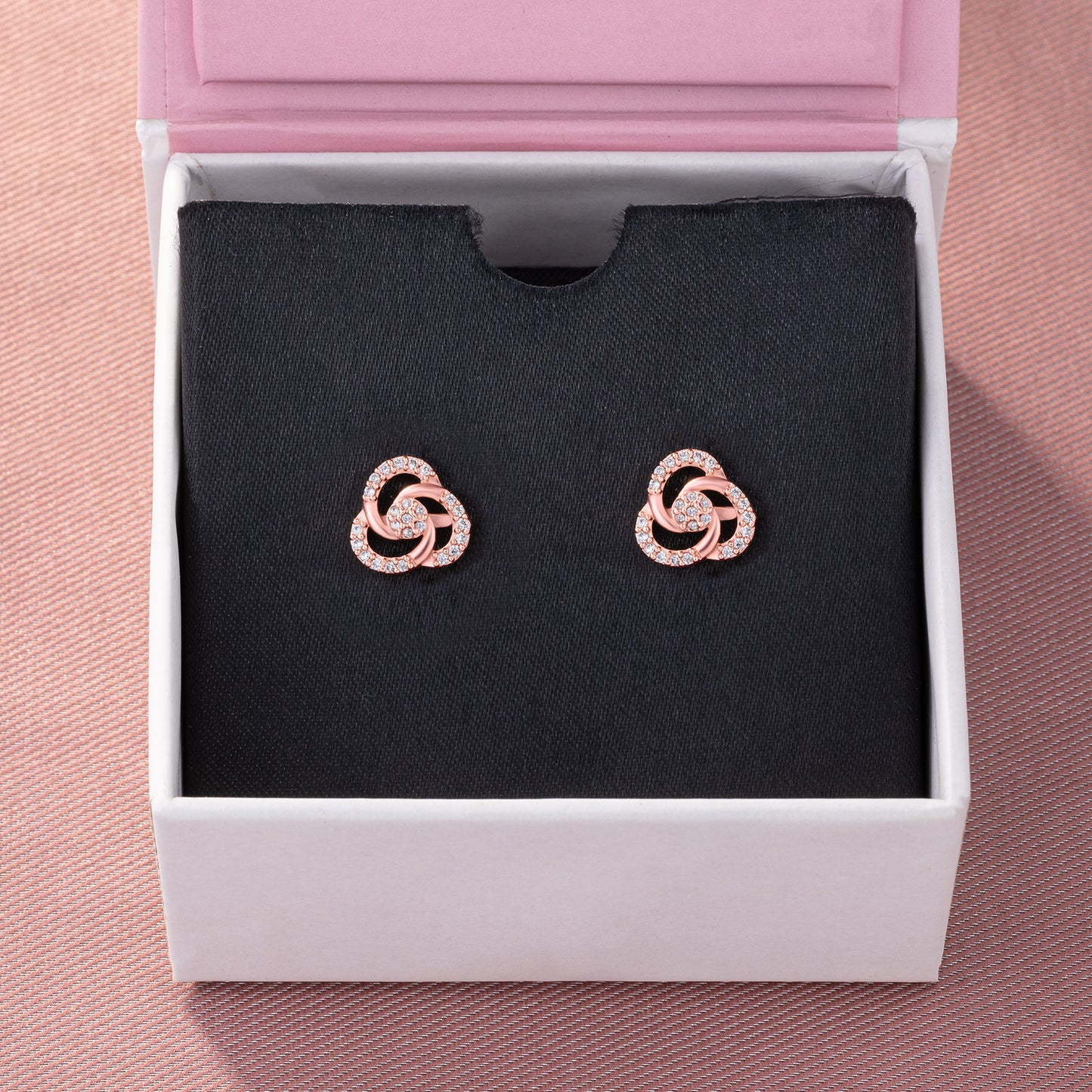 pair of rose gold and diamond earrings