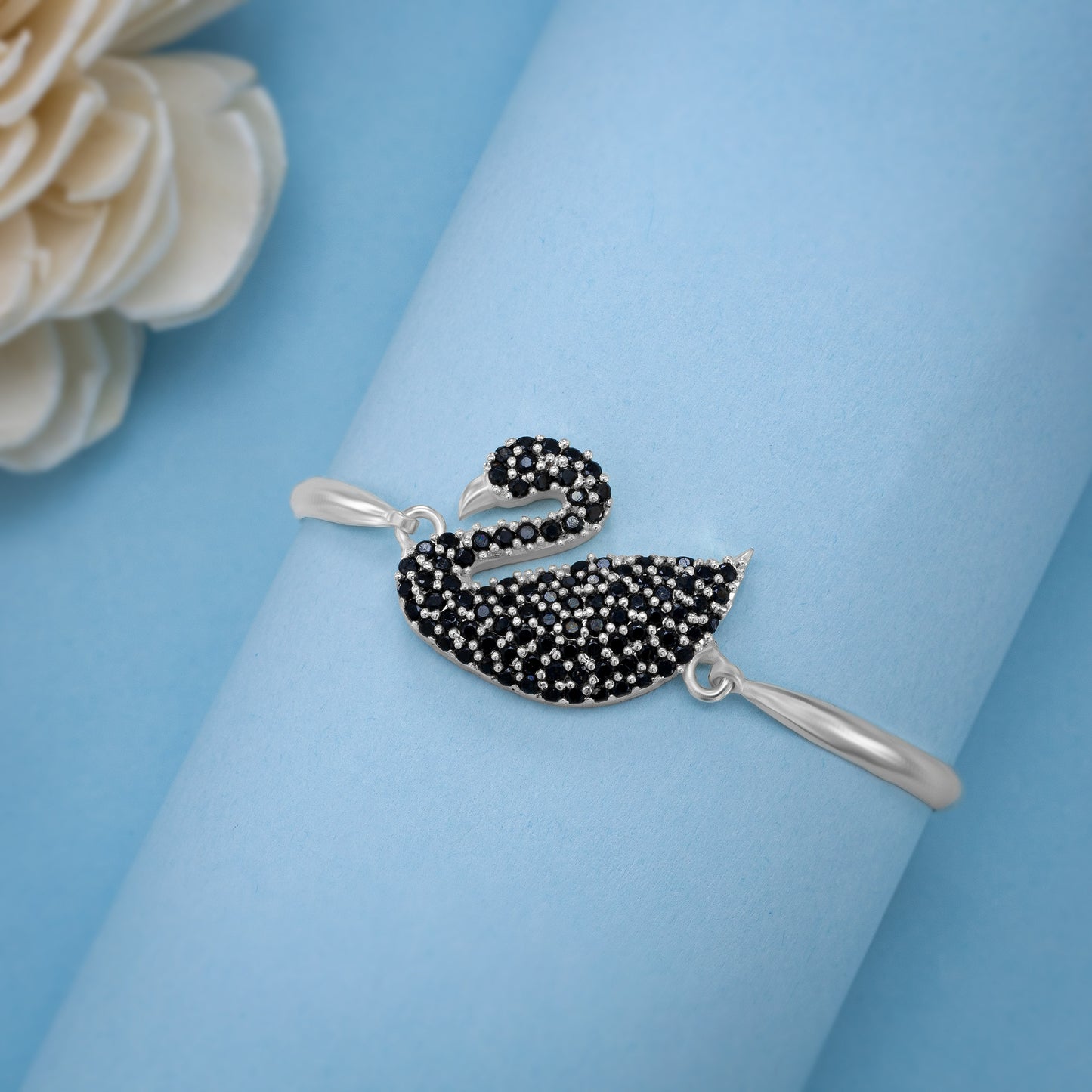 silver bracelet with a swan on it