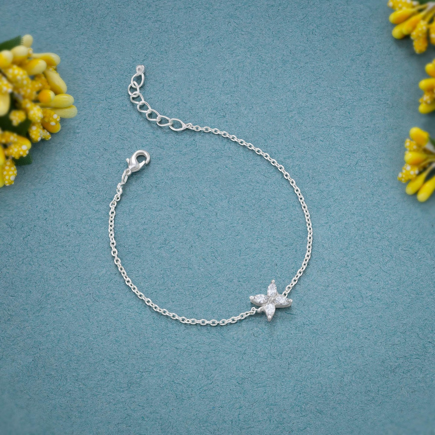 silver bracelet with a small white butterfly