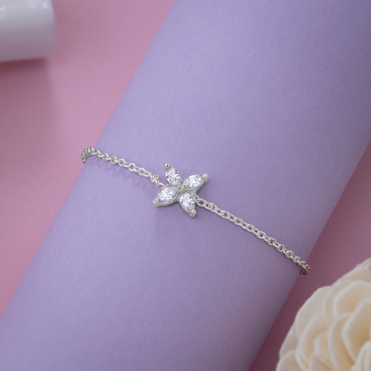 silver bracelet with a small white butterfly