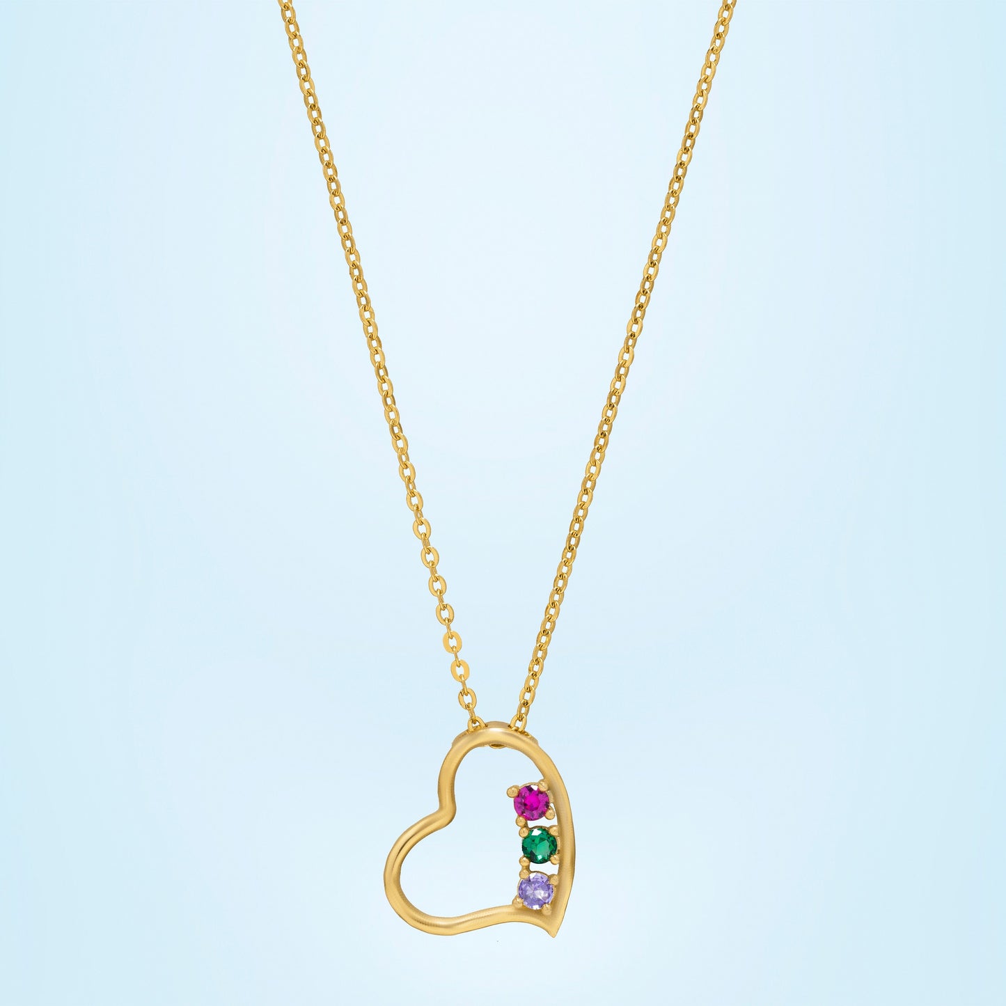 golden necklace with a heart pendant and a rainbow stone