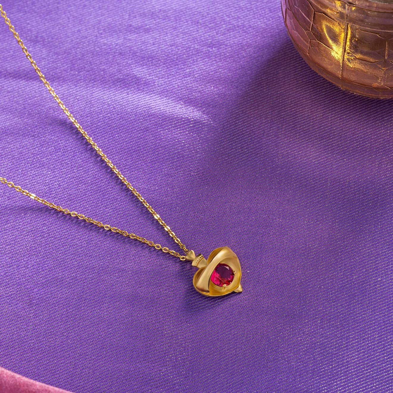 golden necklace with a heart shaped pendant