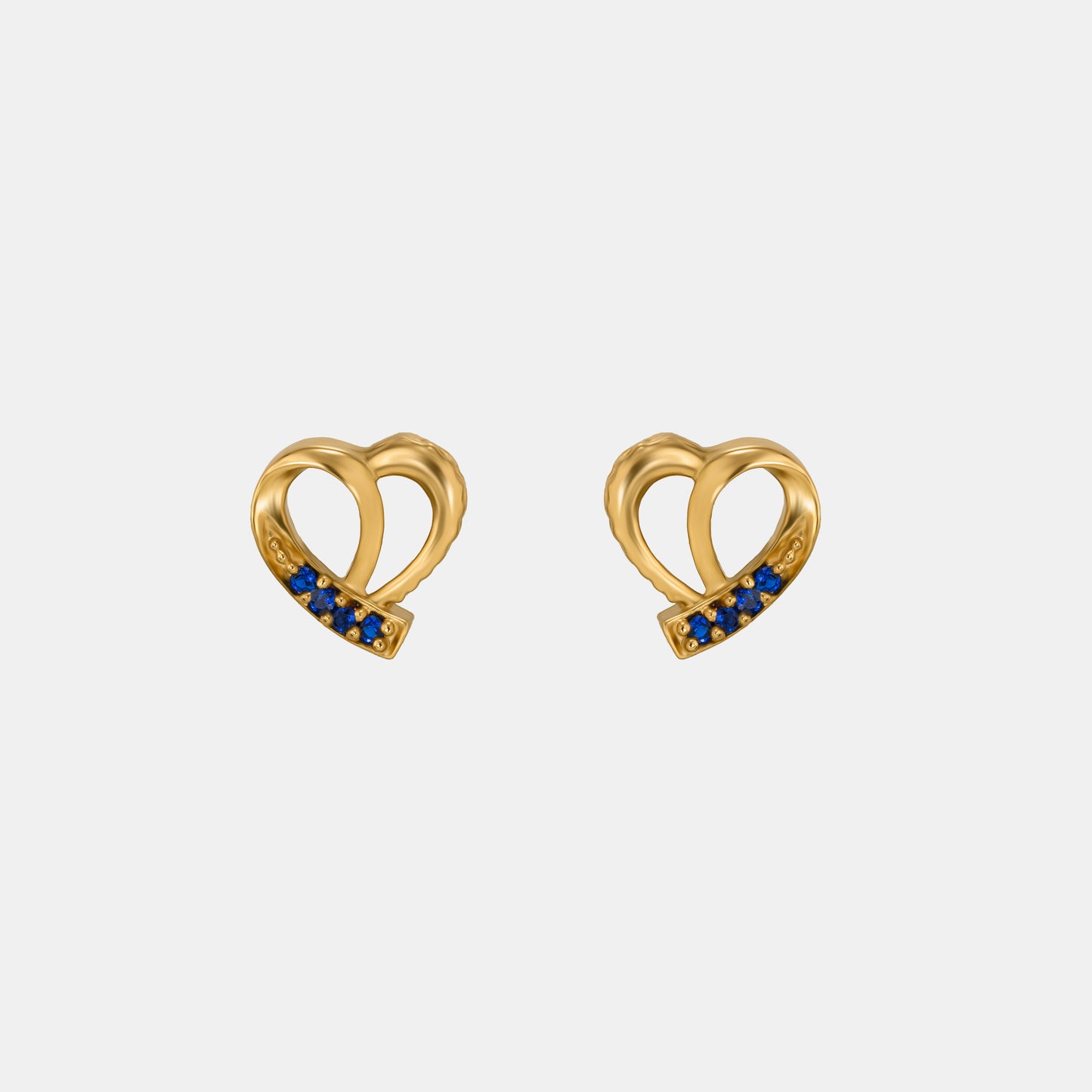 pair of golden earrings with sapphire stones