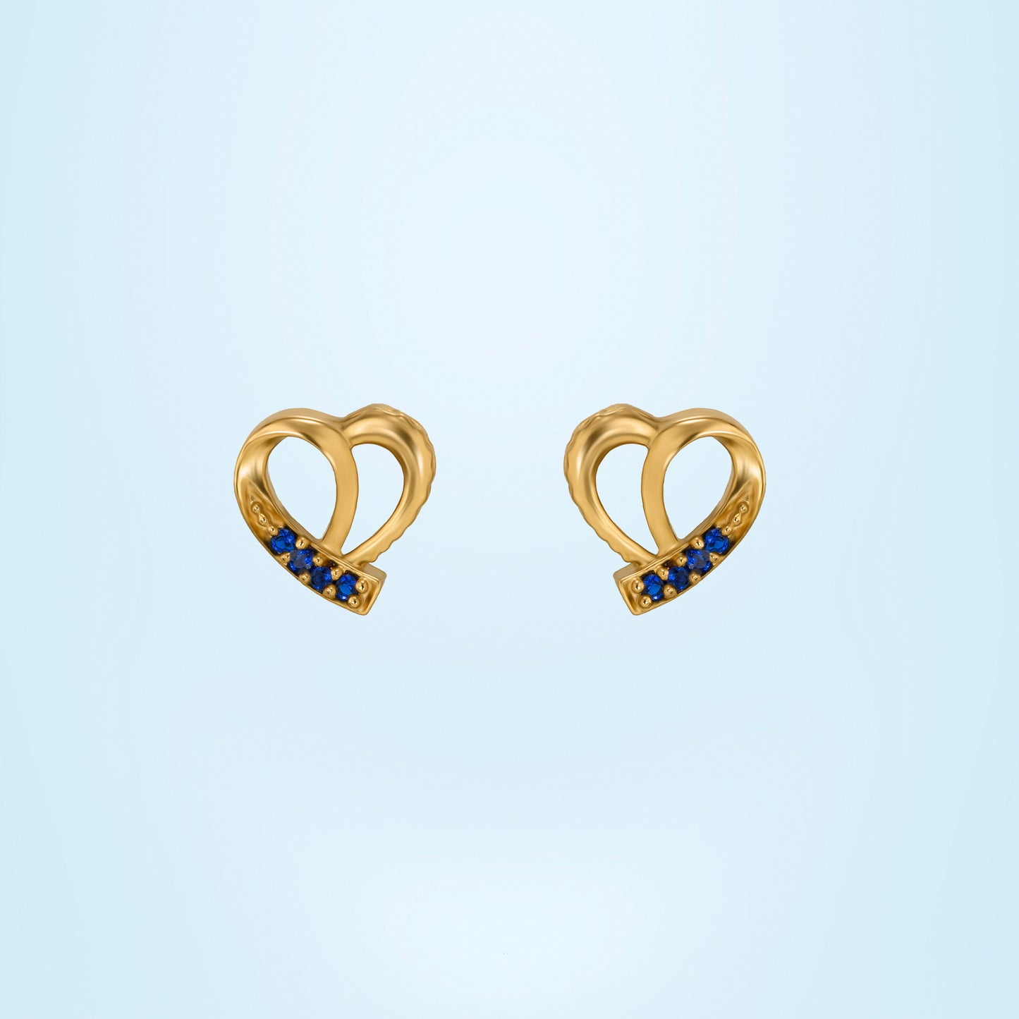 pair of golden earrings with sapphire stones