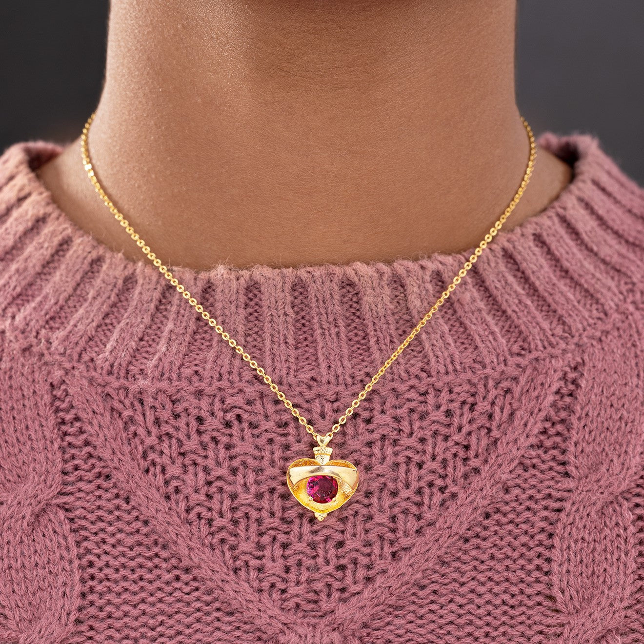 golden necklace with a heart shaped pendant