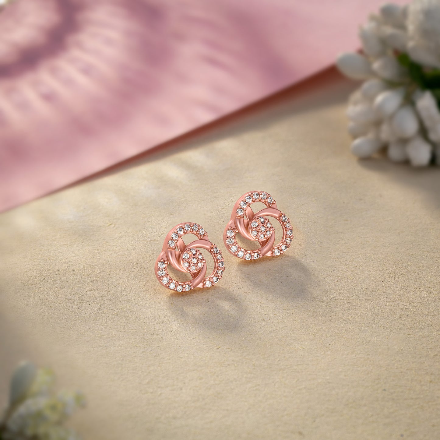 pair of rose gold and diamond earrings