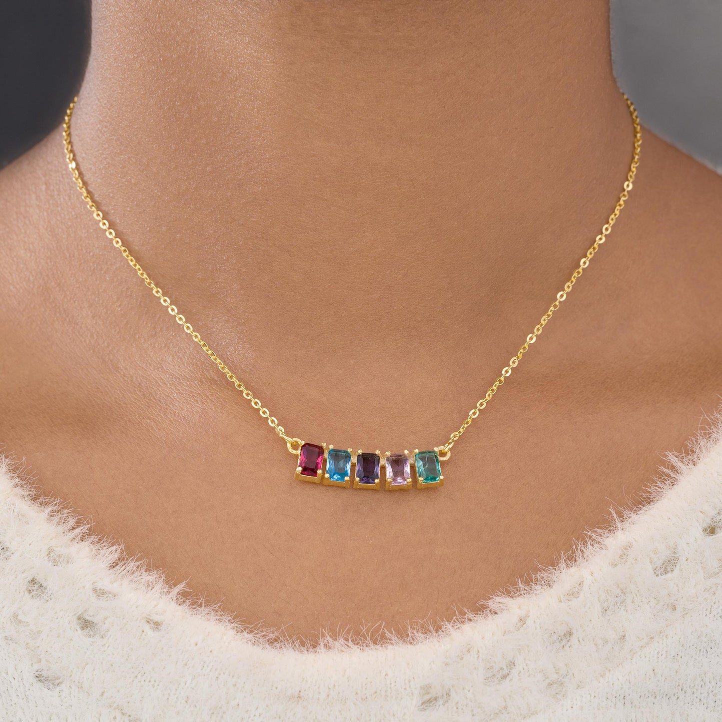 golden necklace with five rainbow stones