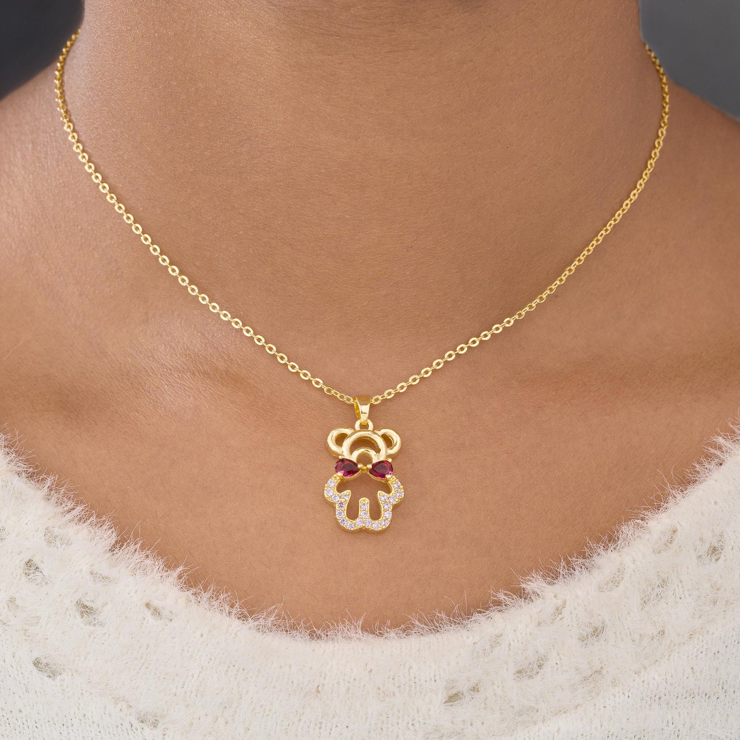 golden necklace with a heart and a diamond