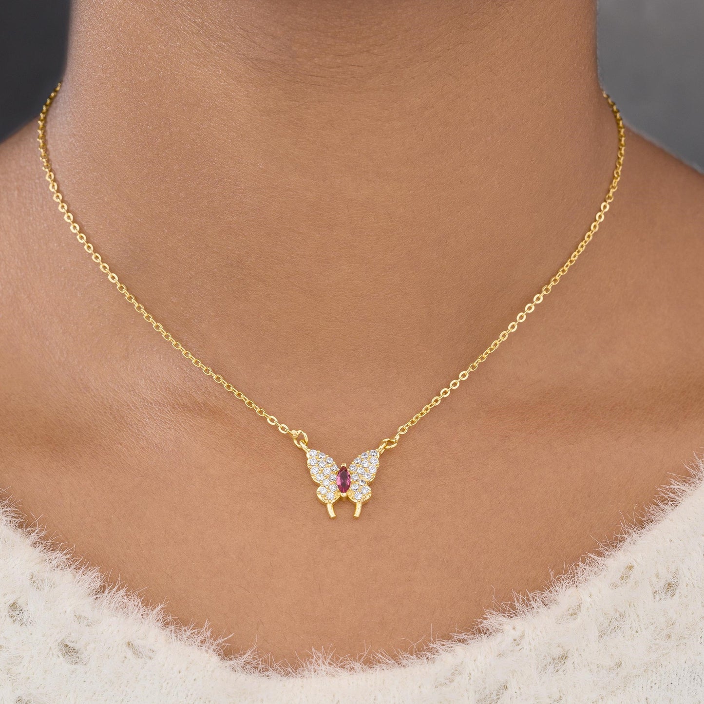 golden necklace with a butterfly pendant