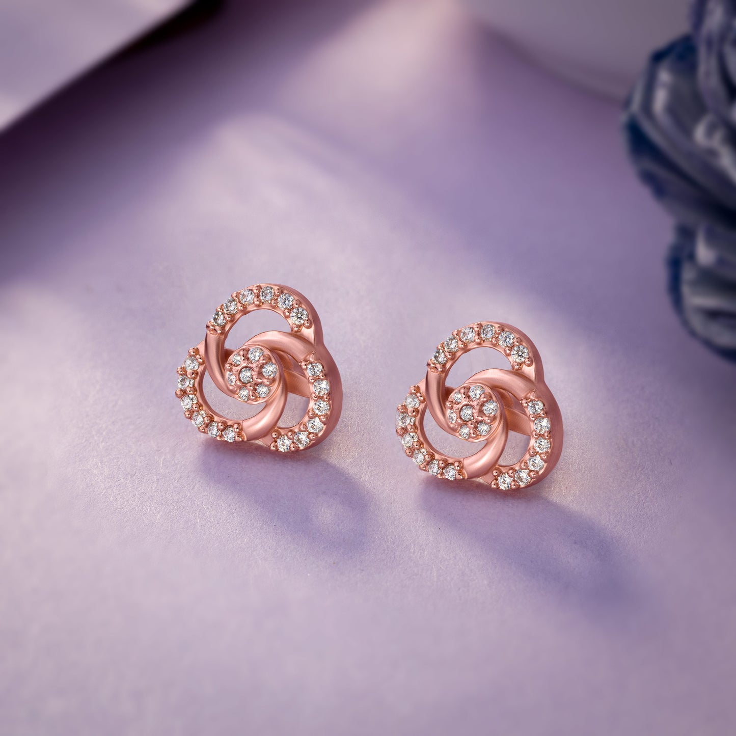 pair of rose gold and diamond earrings