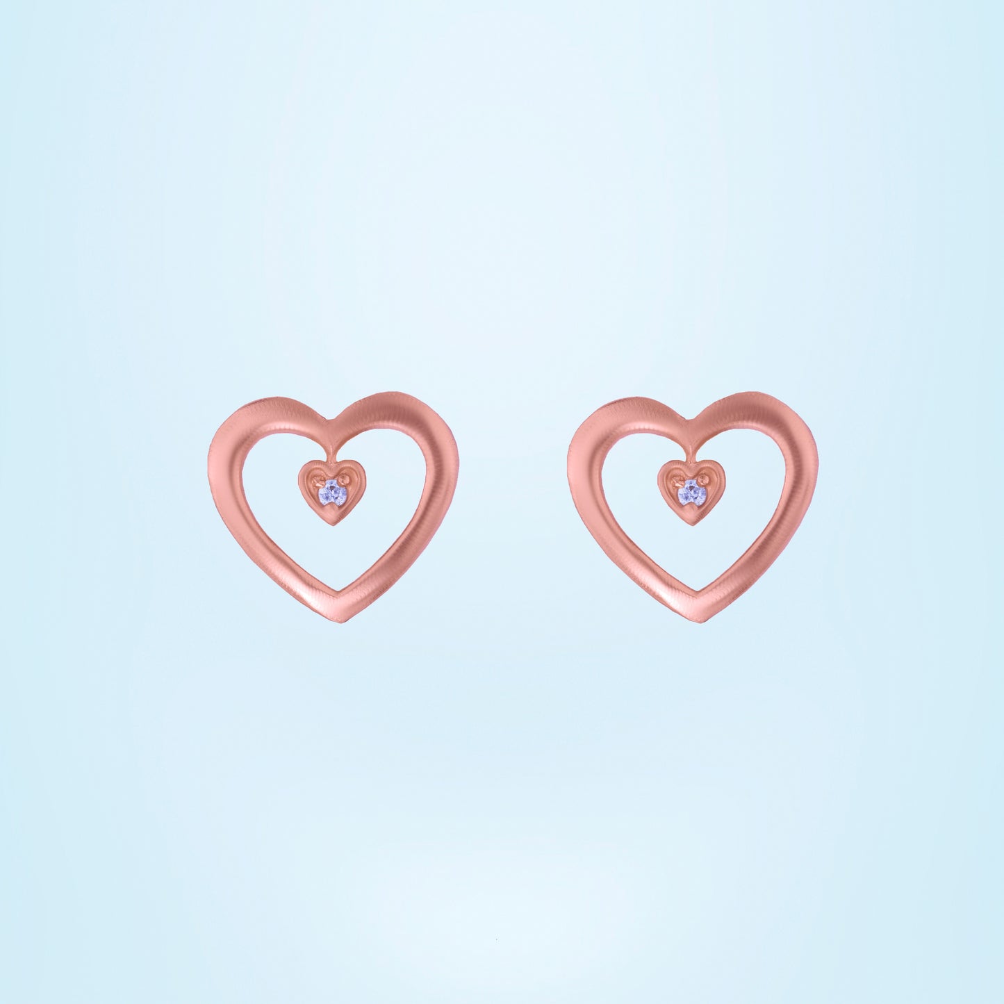 pair of rose gold heart earrings with diamond