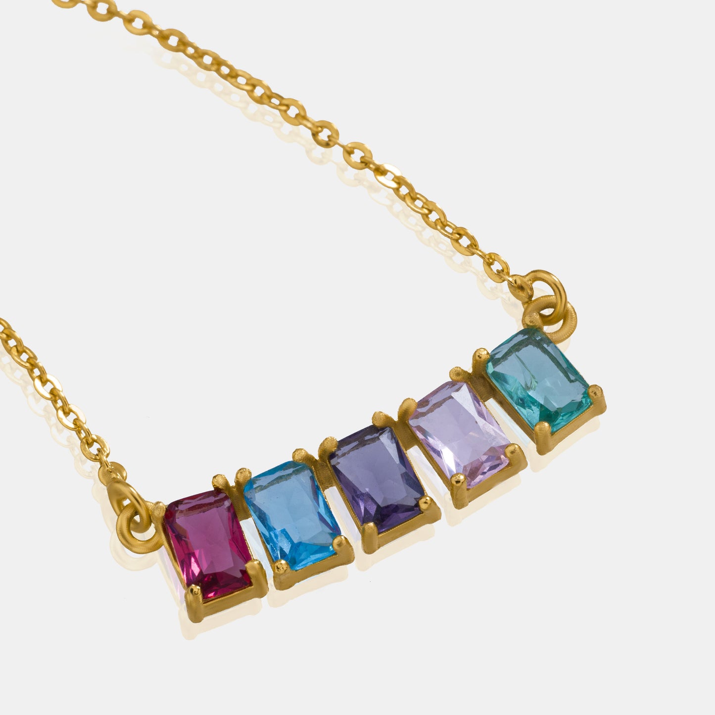 golden necklace with five rainbow stones