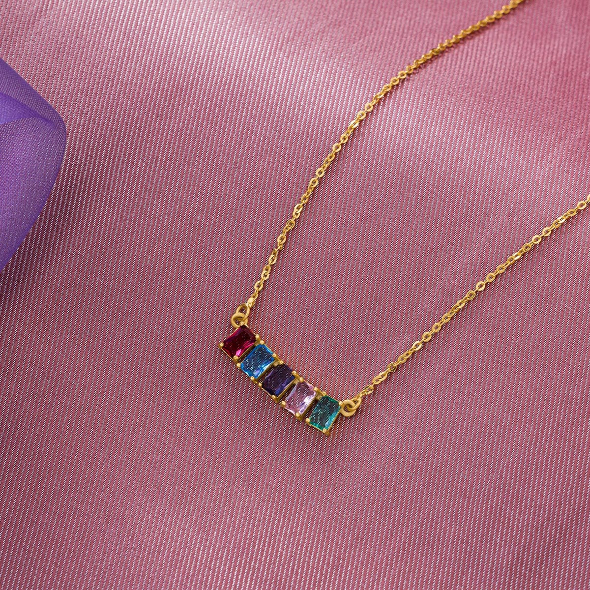 golden necklace with five rainbow stones