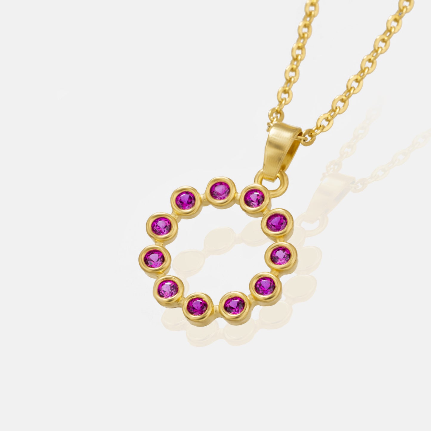 golden necklace with a purple stone pendant