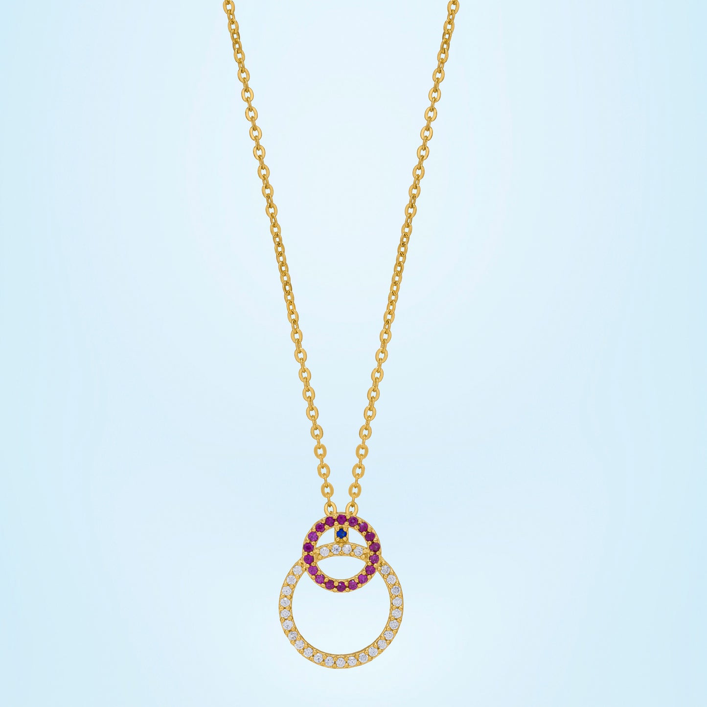 golden necklace with a diamond and ruby stone