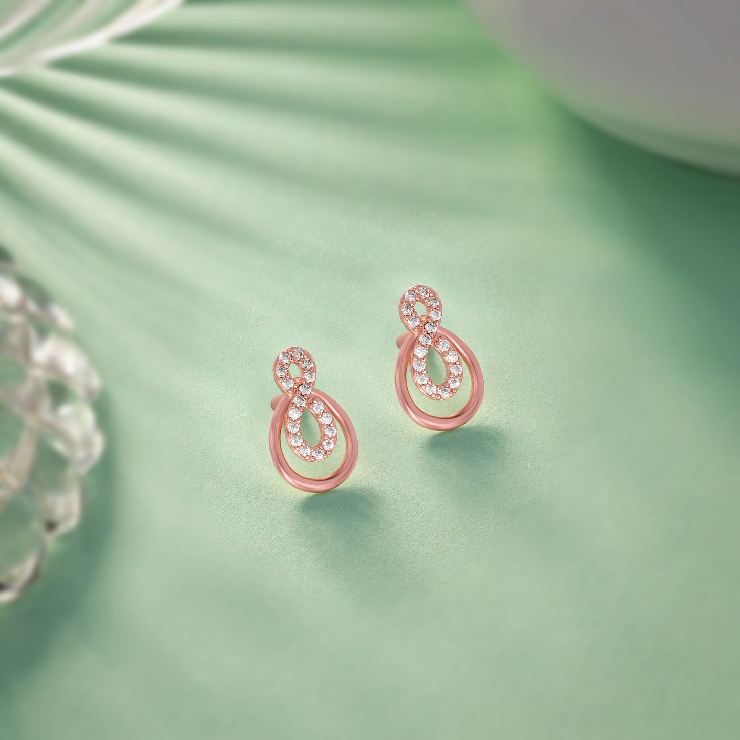 pair of rose gold earrings with diamonds