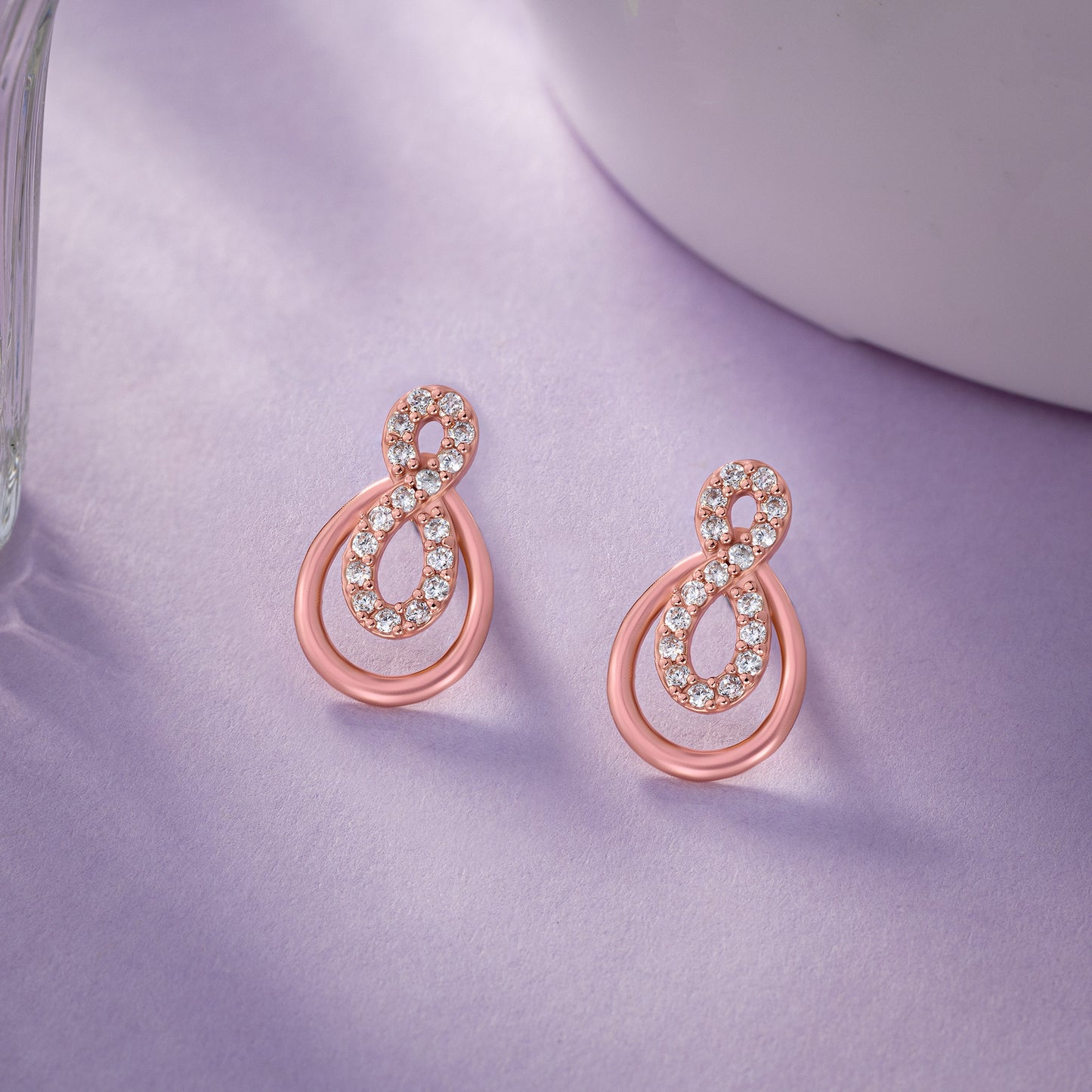 pair of rose gold earrings with diamonds