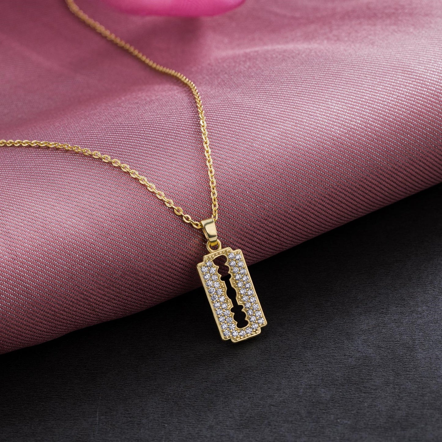 golden necklace with a diamond bar pendant