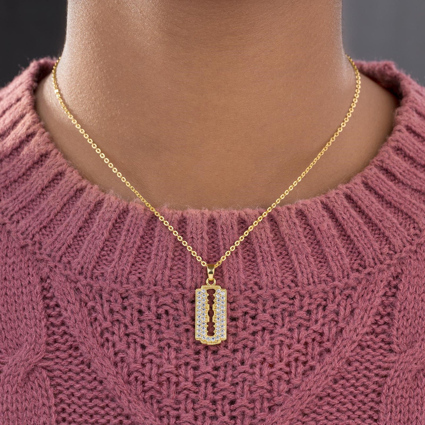 golden necklace with a diamond bar pendant