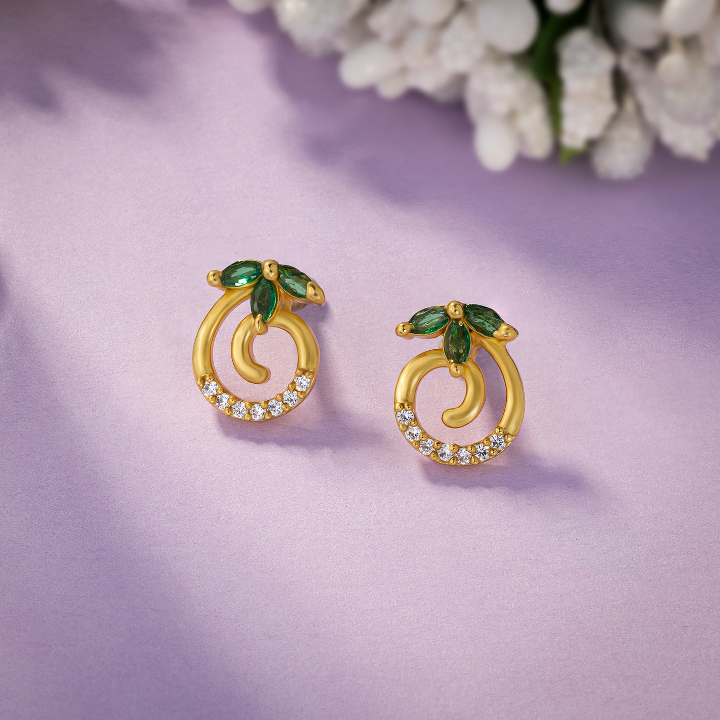 pair of golden earrings with emerald and diamonds