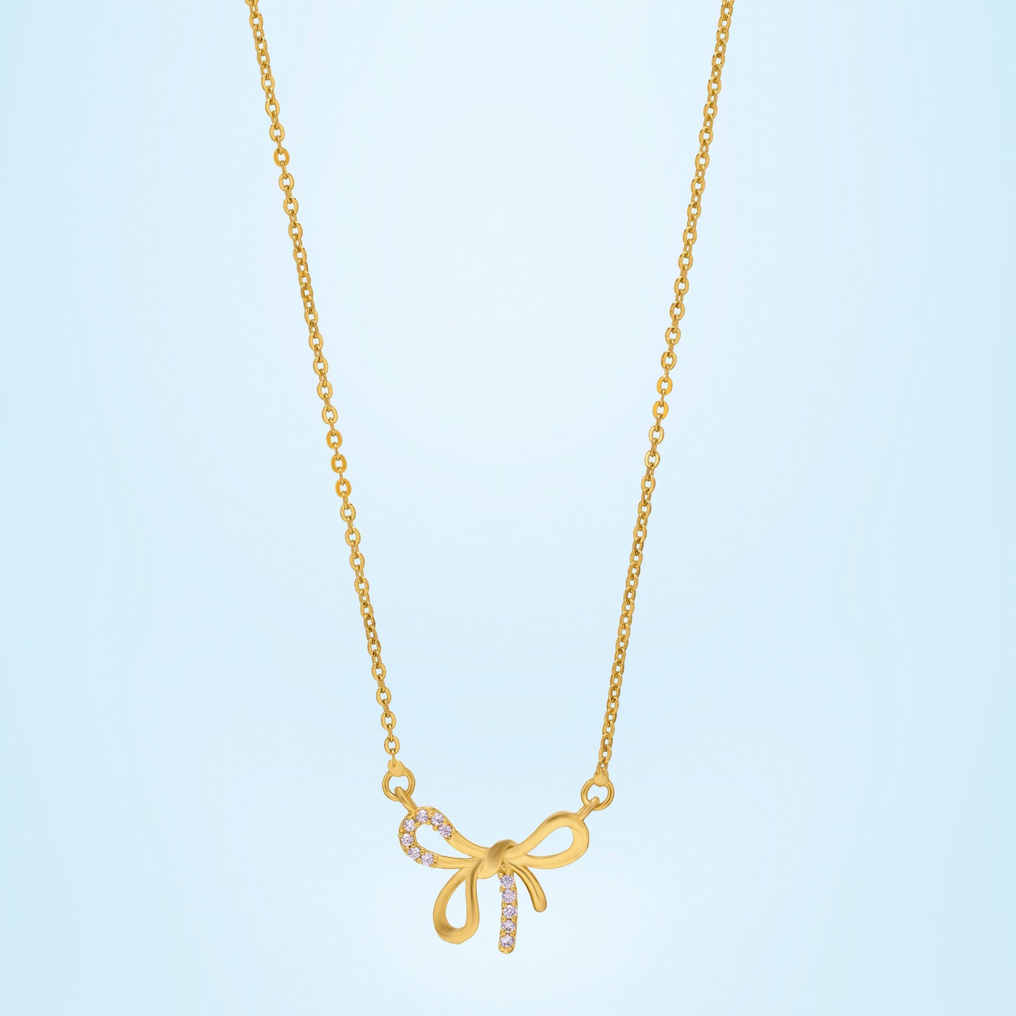 golden necklace with a bow and a diamond