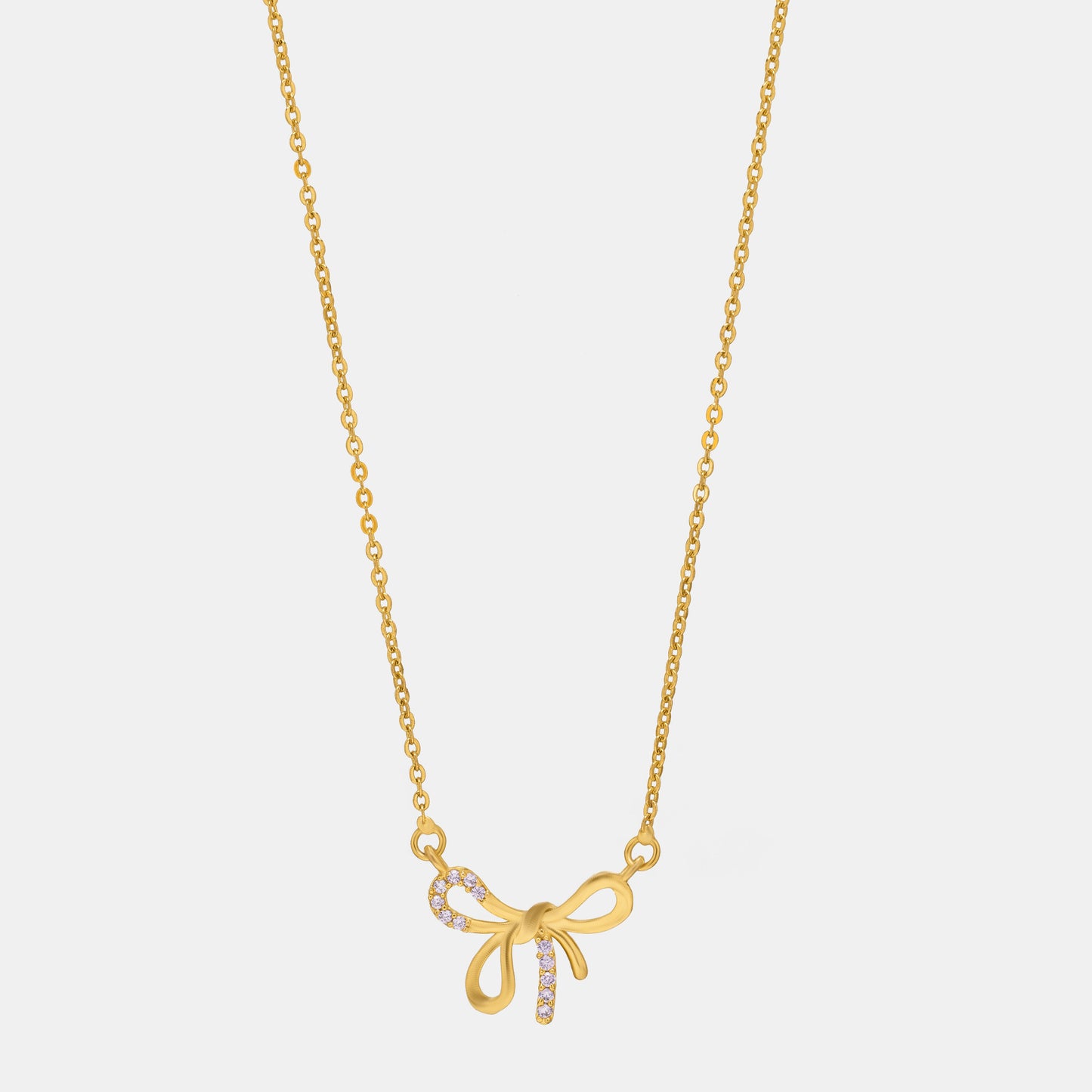 golden necklace with a bow and a diamond