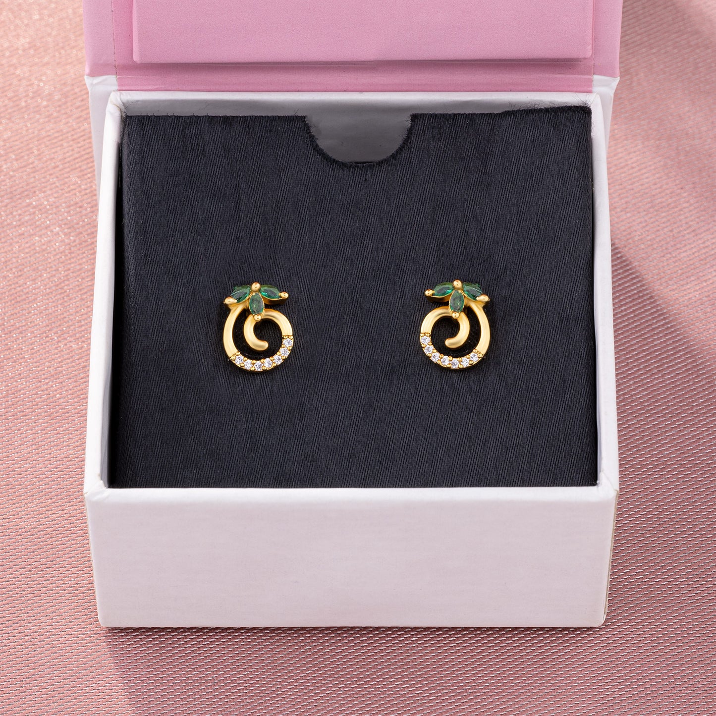 pair of golden earrings with emerald and diamonds