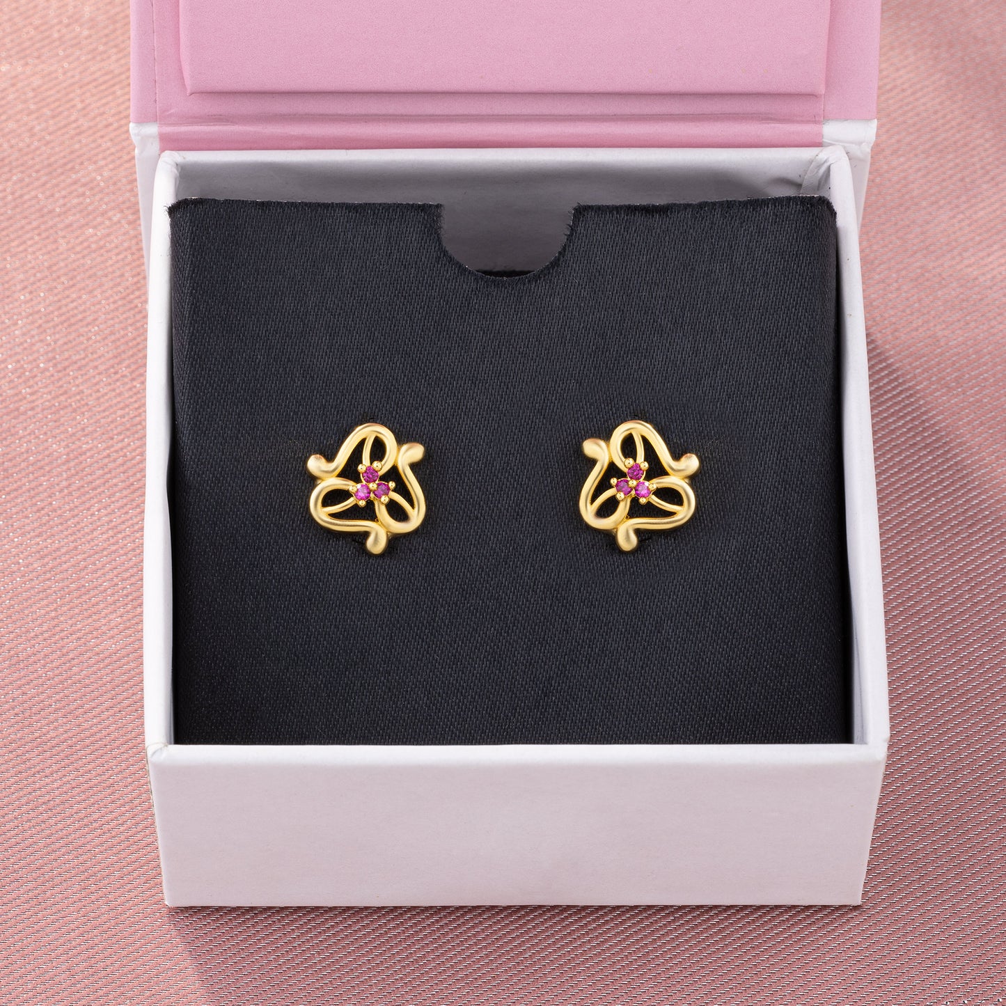 pair of golden earrings with stones