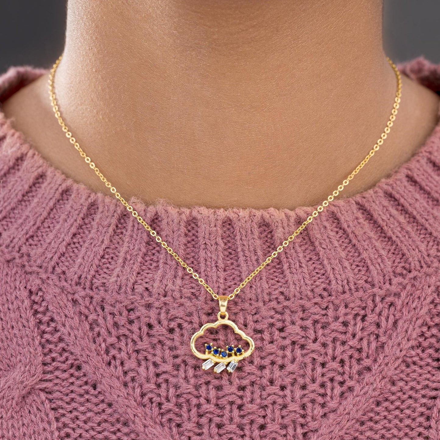 golden necklace with a heart pendant and a small diamond