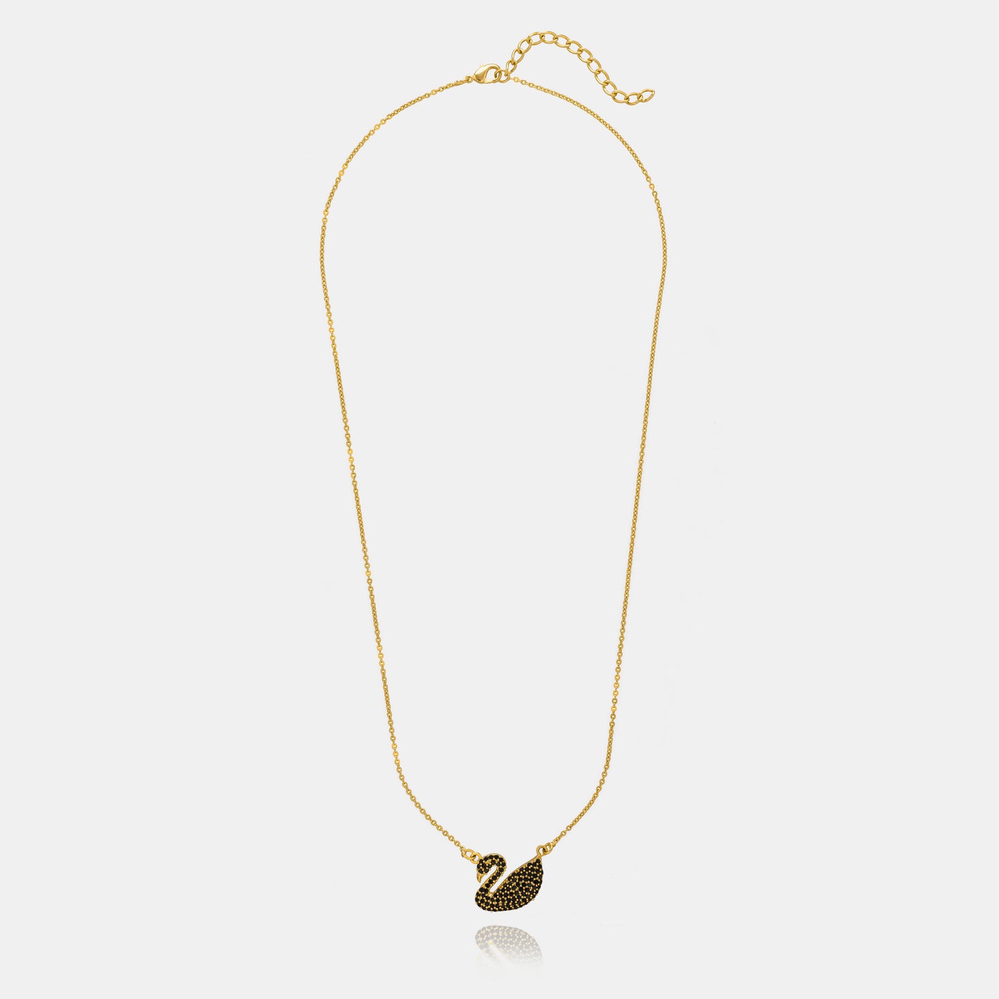 golden necklace with a stone swan