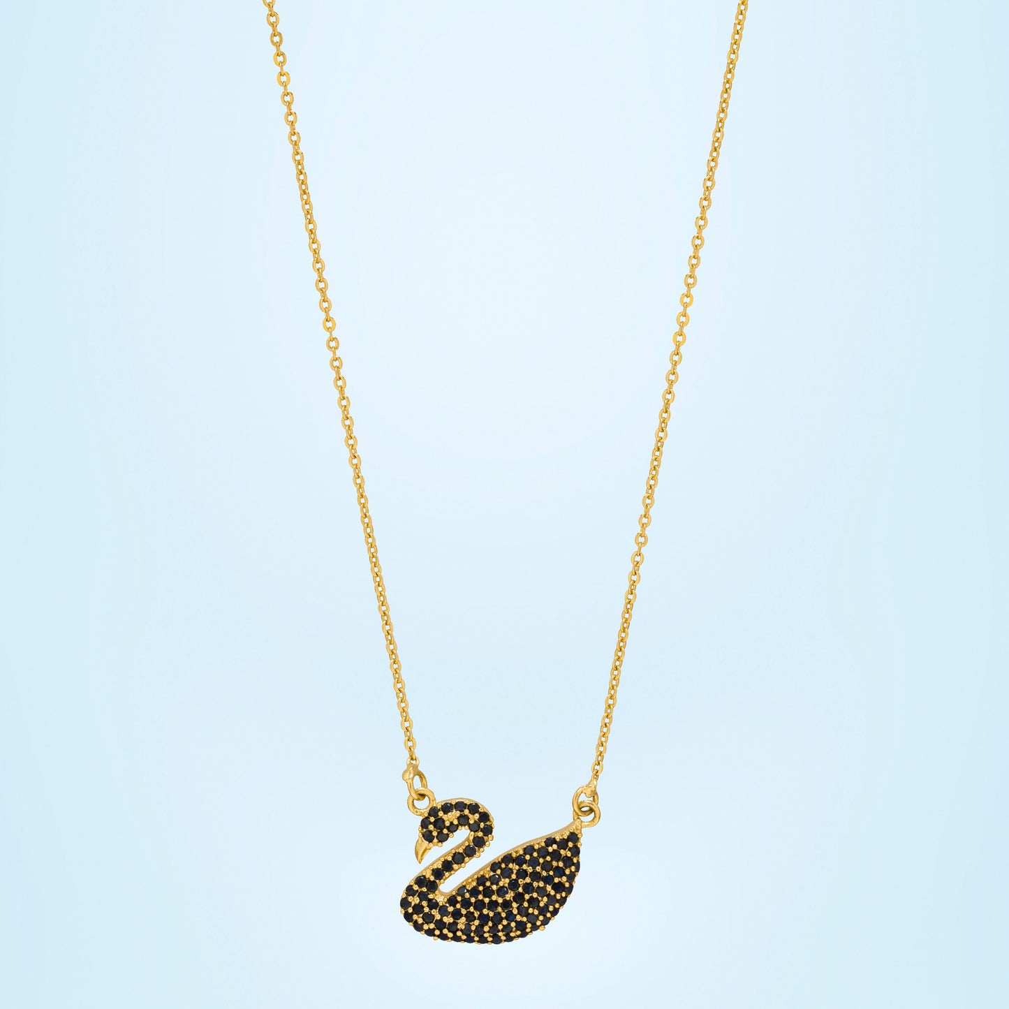 golden necklace with a stone swan