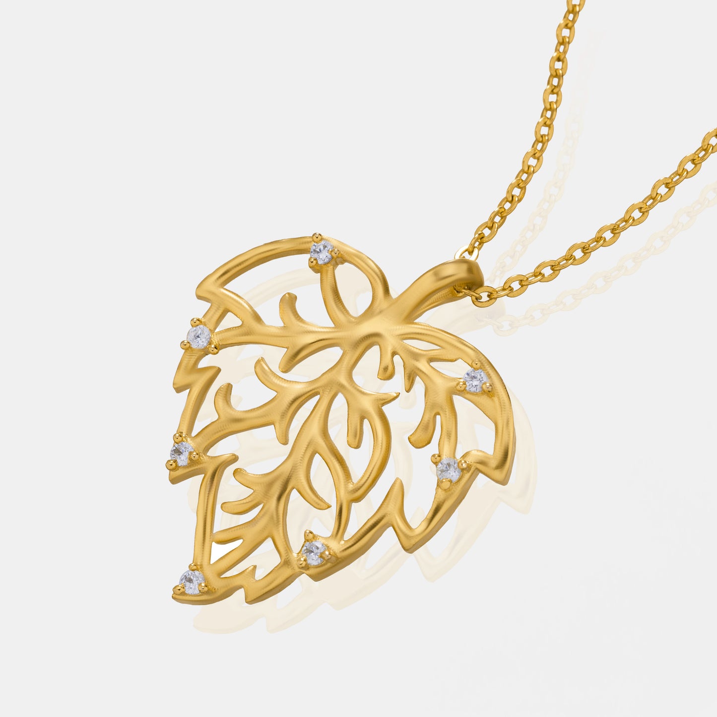 golden necklace with a leaf design on it