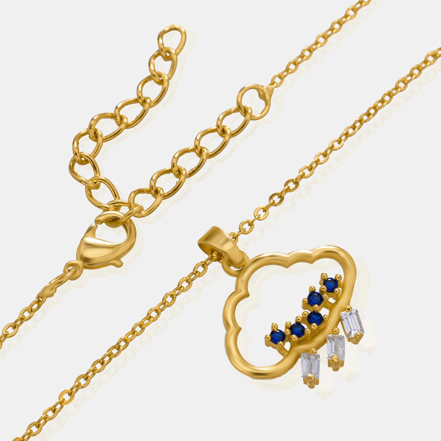 golden necklace with a heart pendant and a small diamond