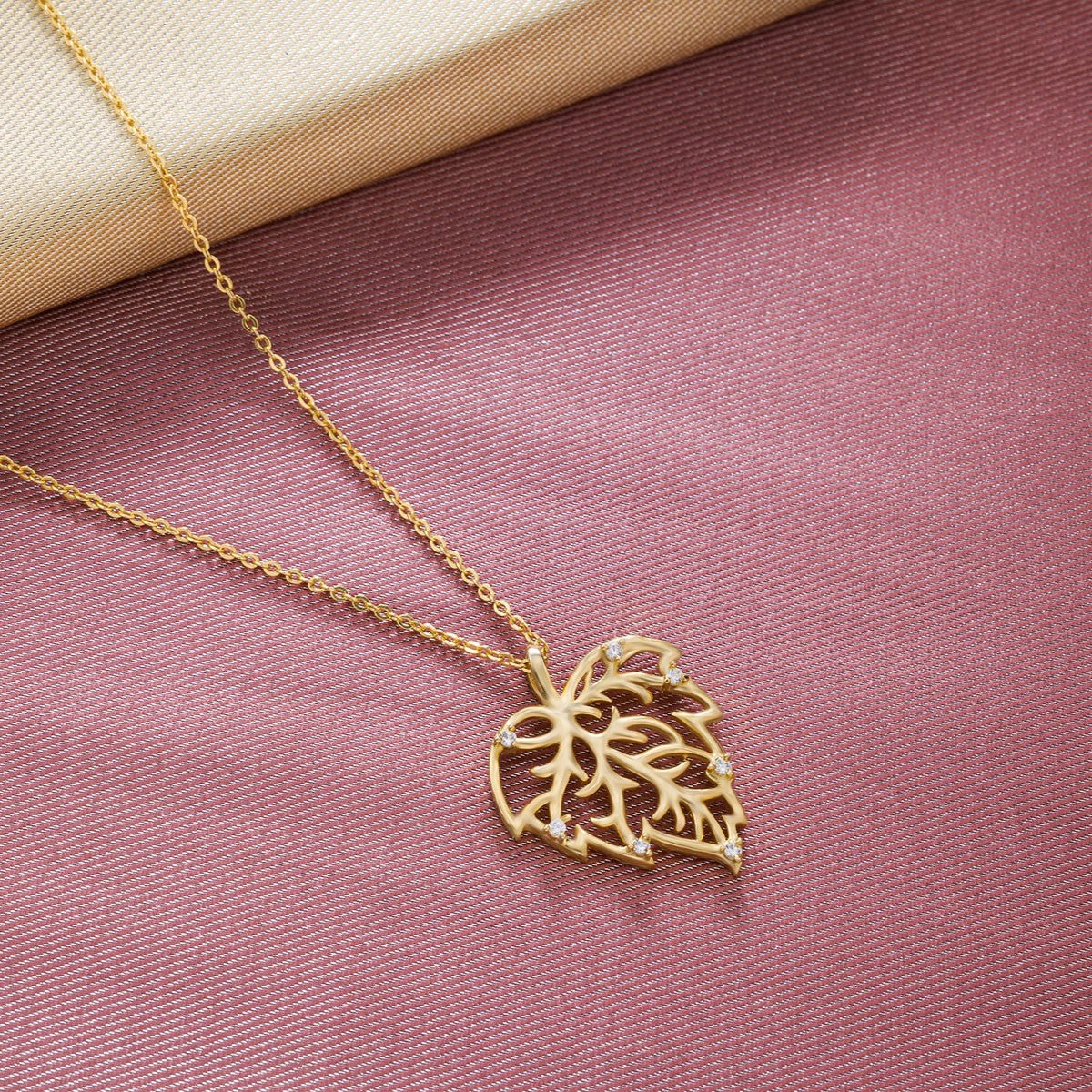 golden necklace with a leaf design on it