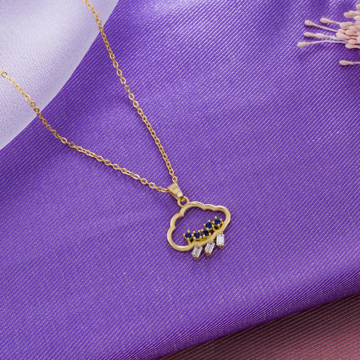 golden necklace with a heart pendant and a small diamond