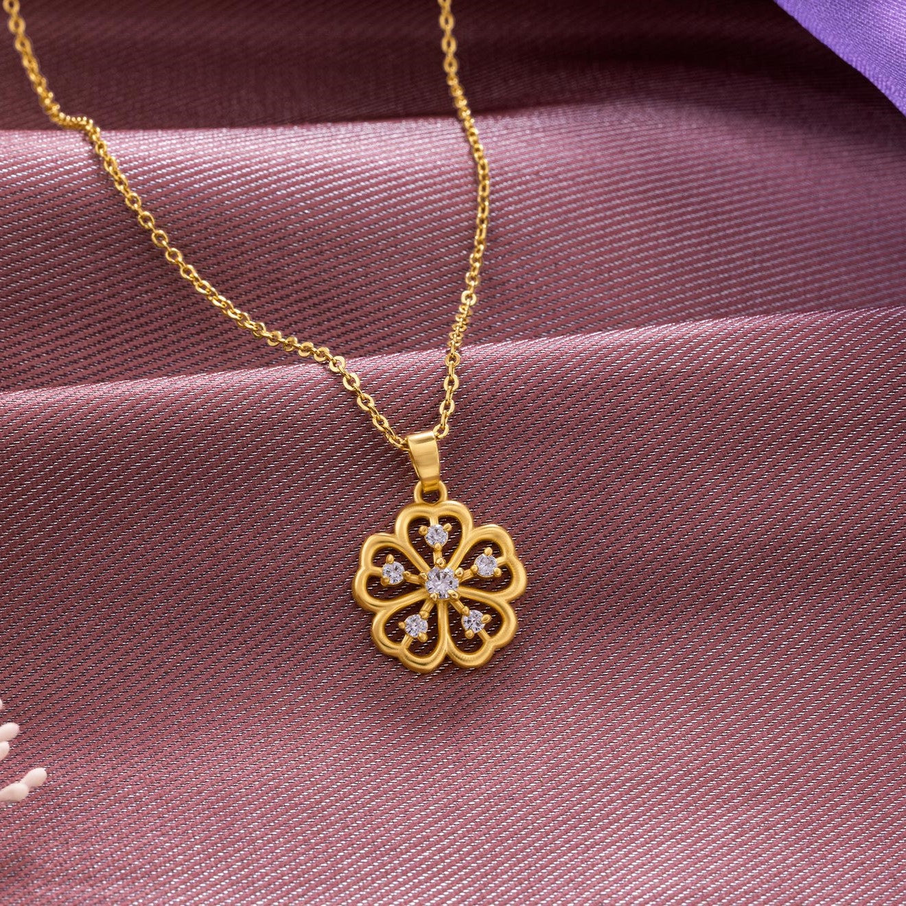 golden necklace with a clover design