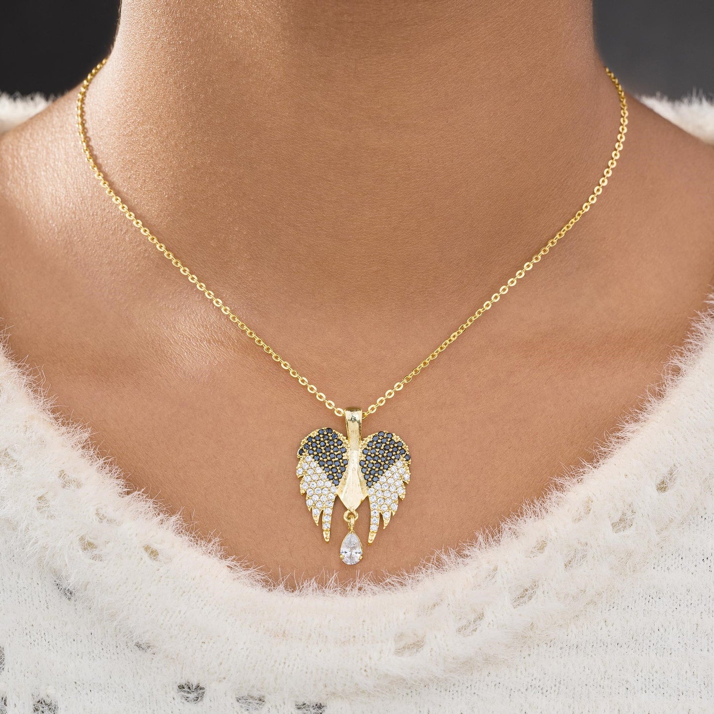 golden necklace with a diamond angel wing pendant