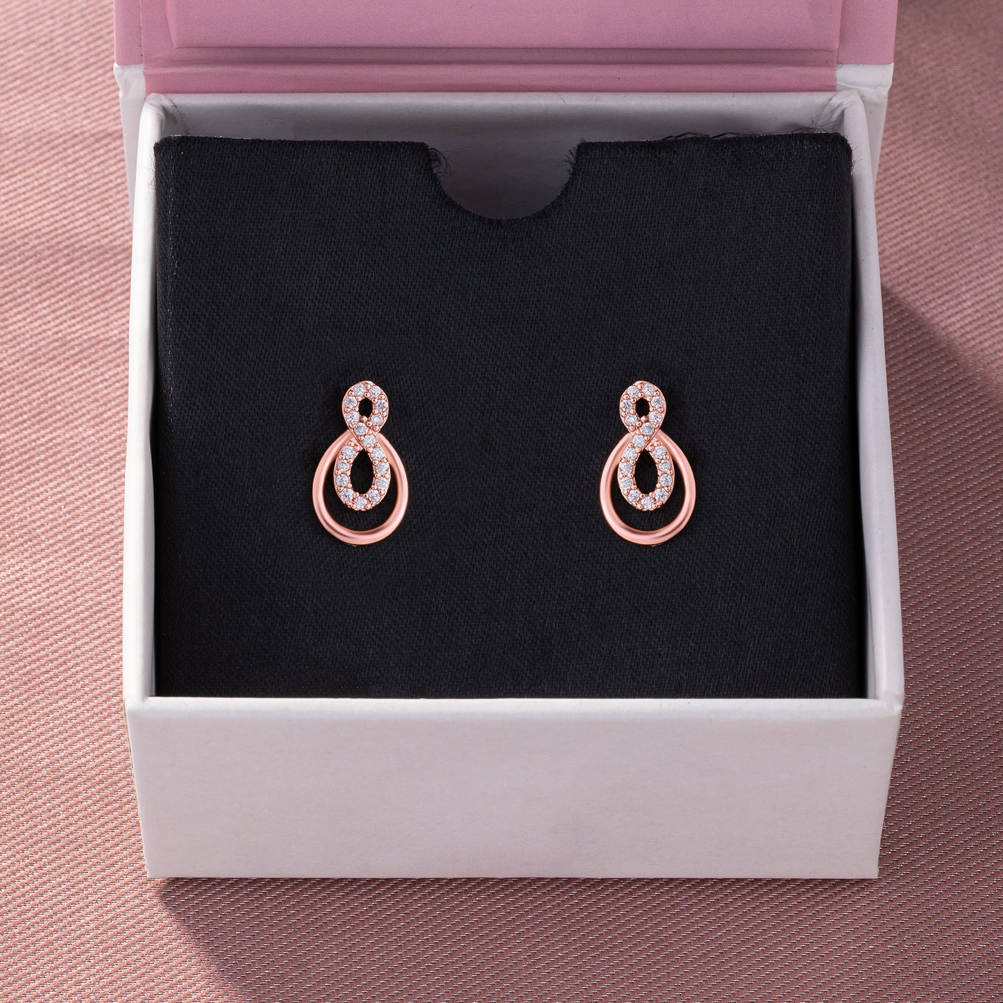 pair of rose gold earrings with diamonds