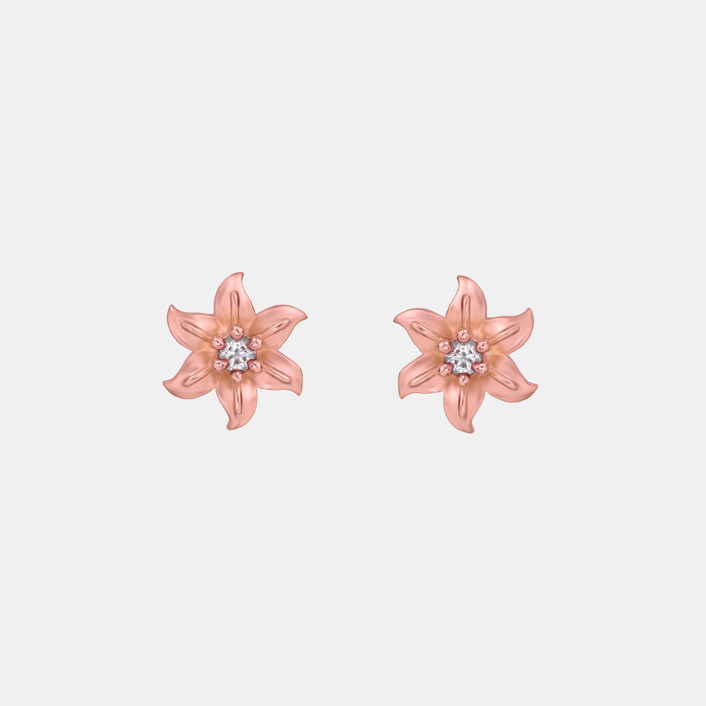 pair of rose gold earrings with white stones