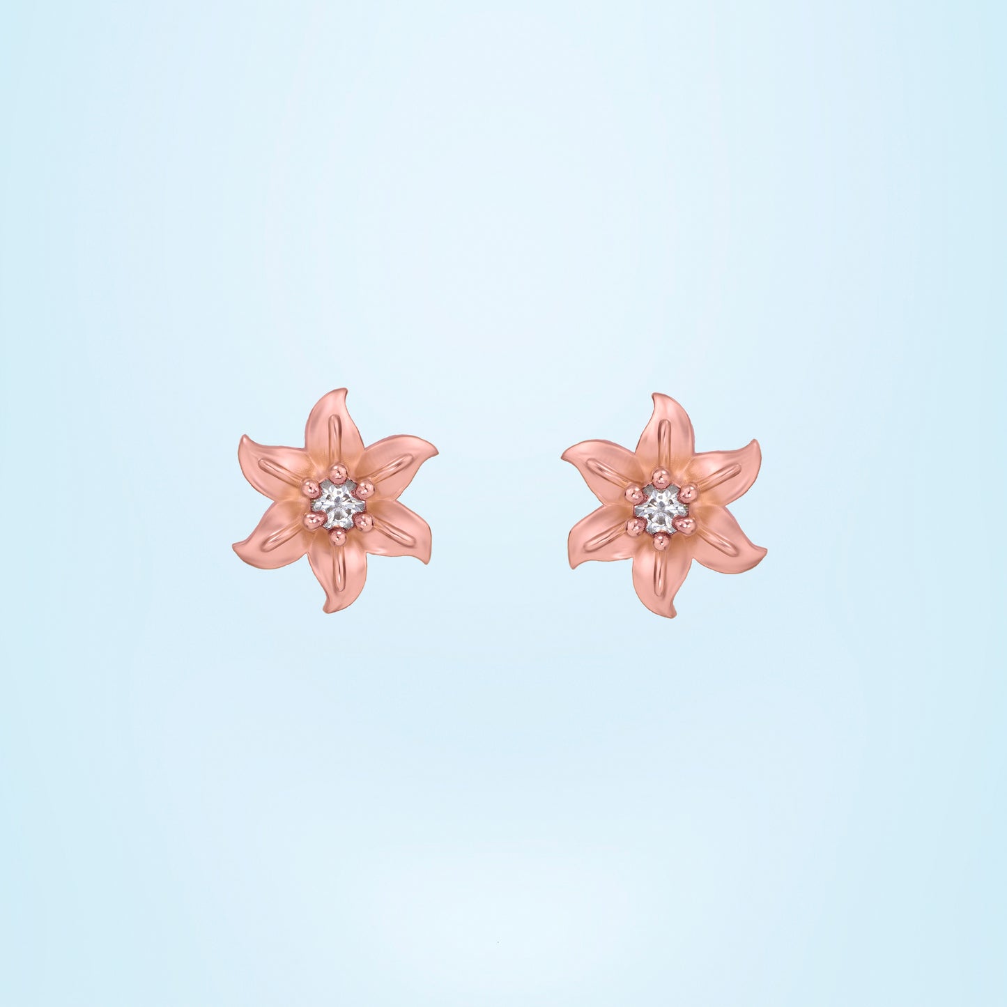 pair of rose gold earrings with white stones