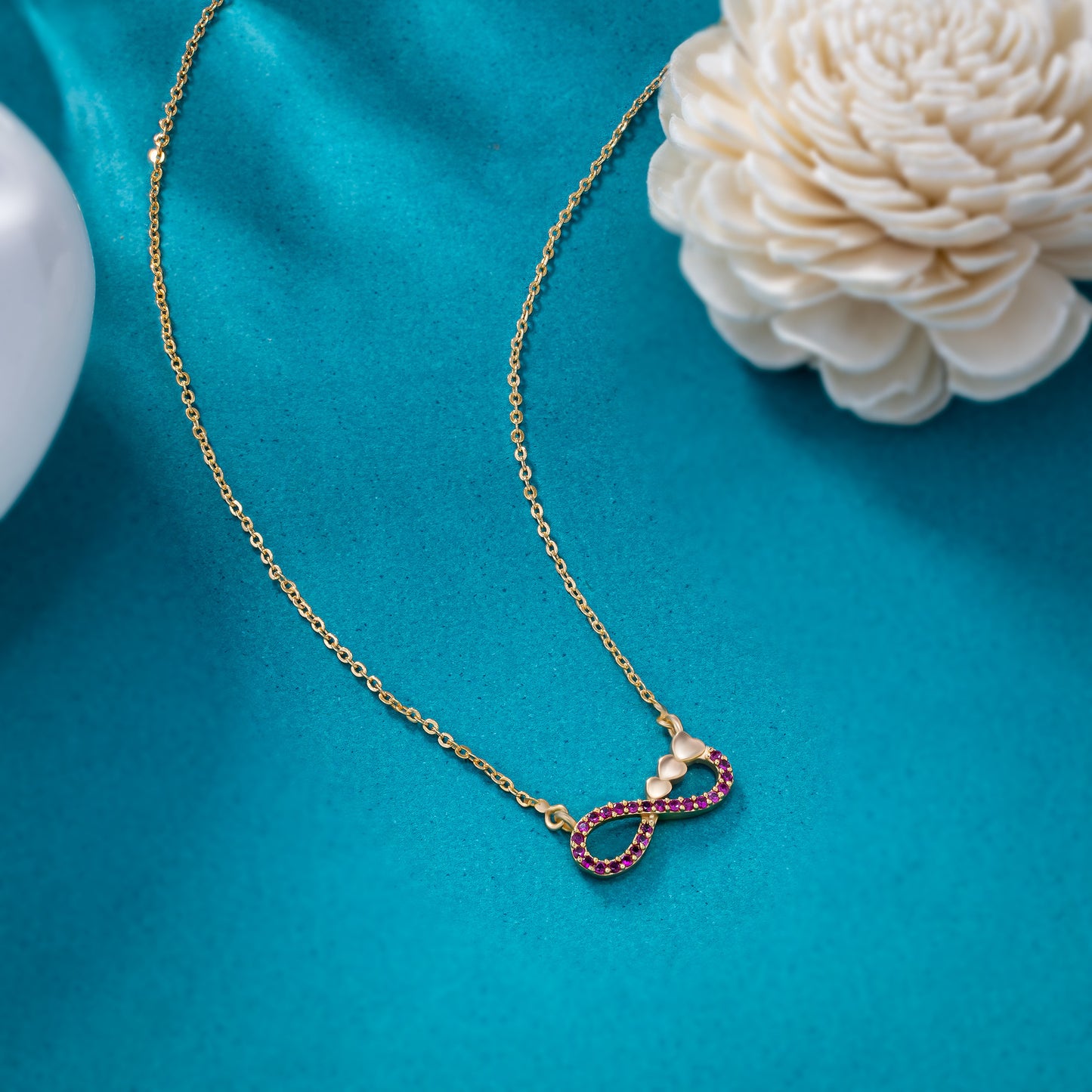 shine bright with this stunning golden necklace featuring a infinity