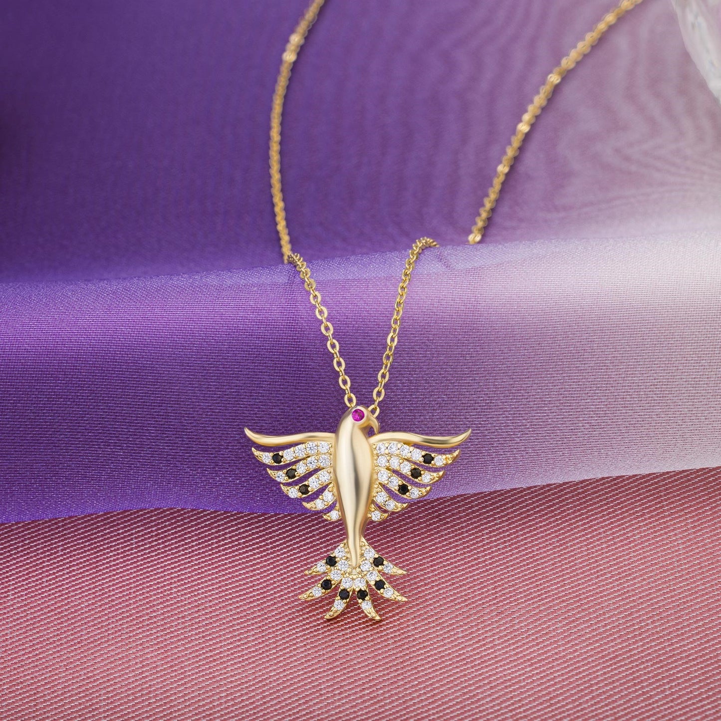 golden necklace with a bird on it