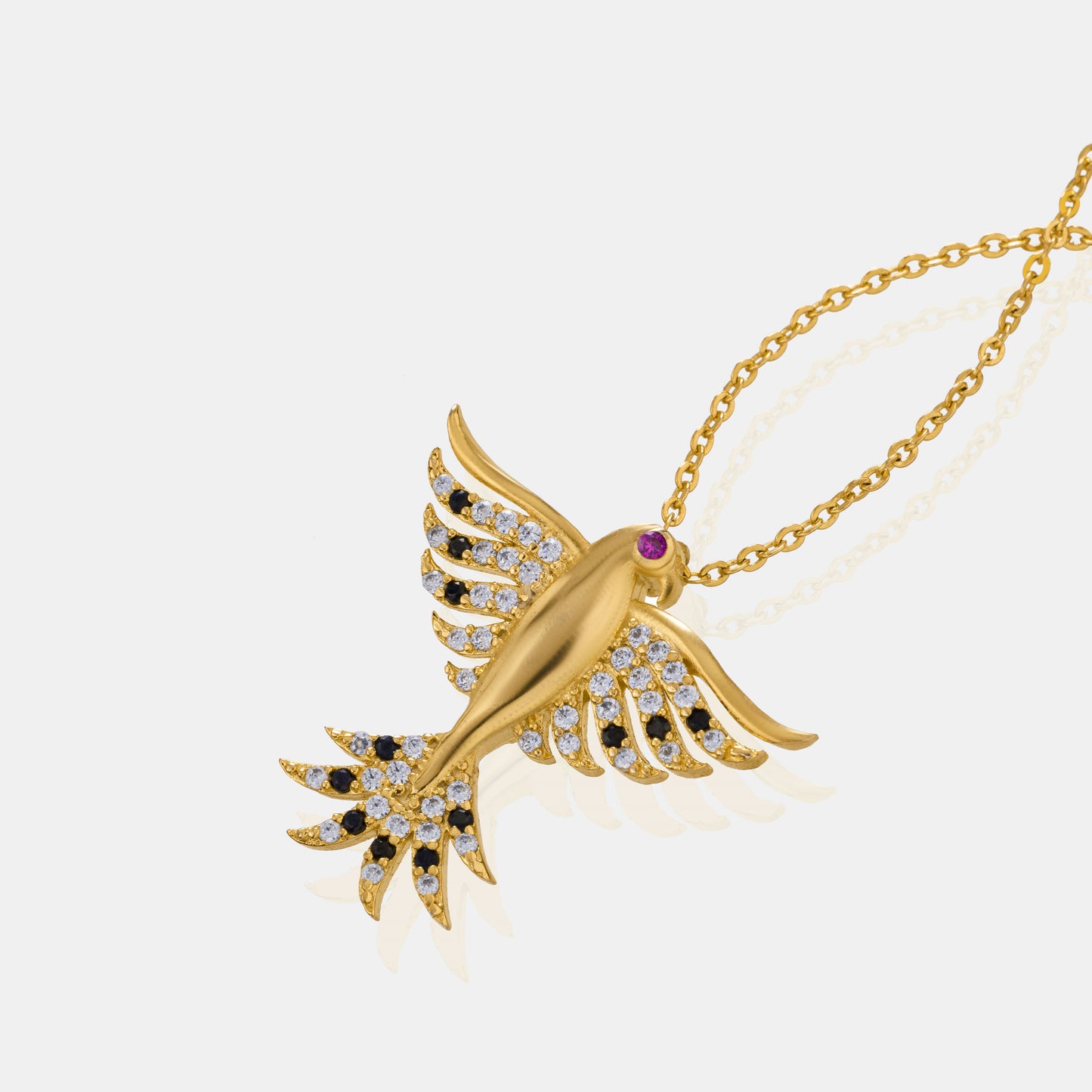 golden necklace with a bird on it