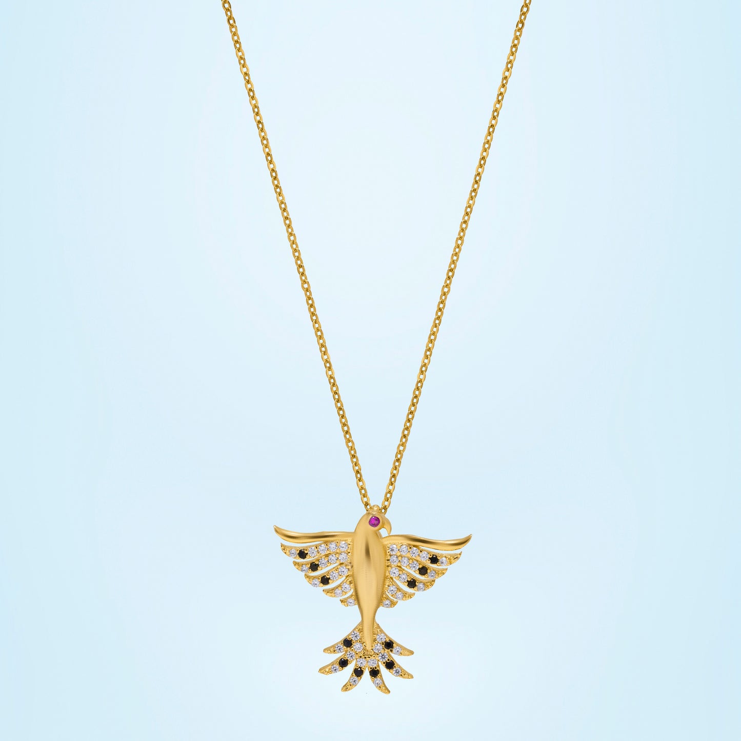 golden necklace with a bird on it