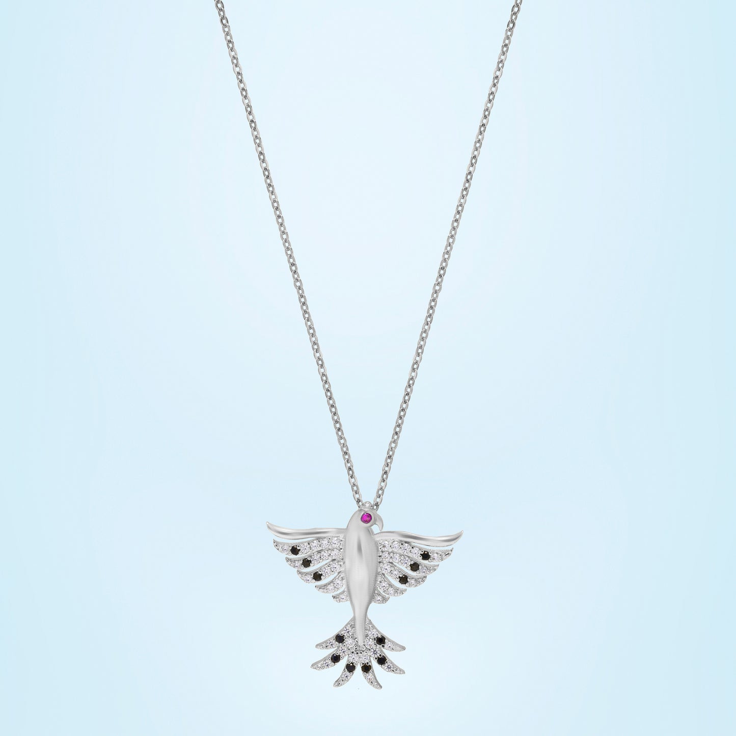 silver necklace with a bird on it