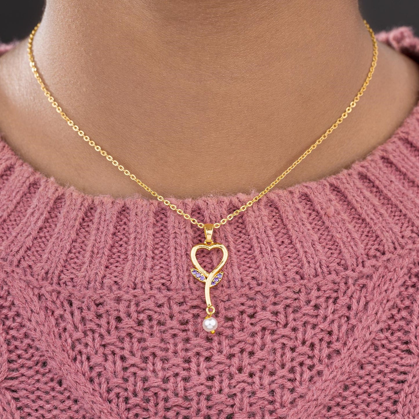 golden necklace with a diamond heart pendant