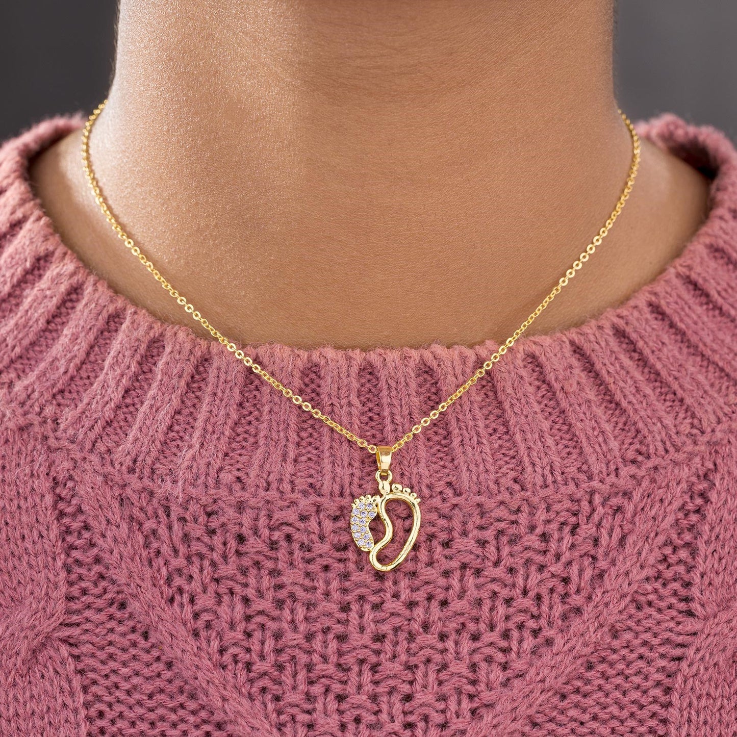 golden necklace with a diamond pendant