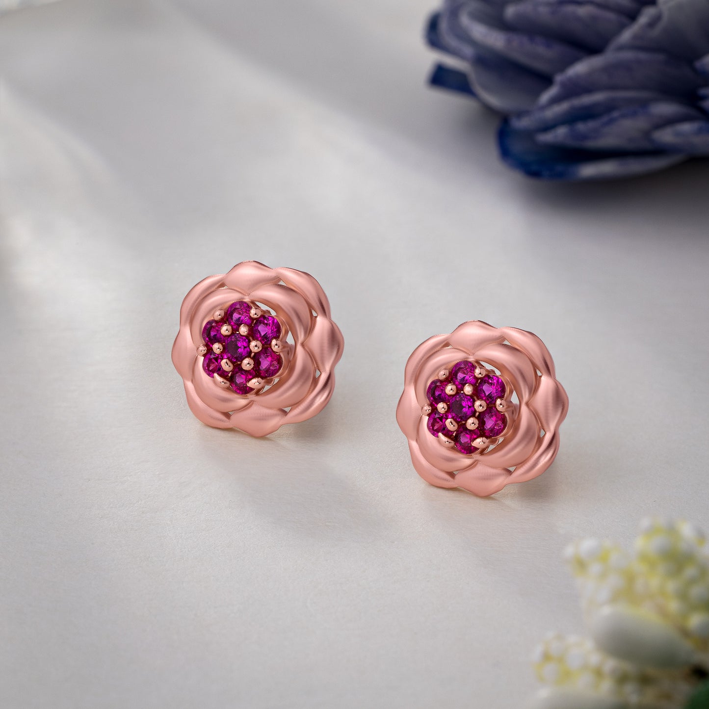 rose gold flower stud earrings with red diamonds